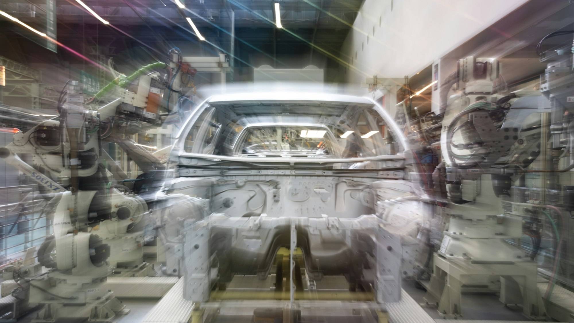 Vehicle body moving along a robotic assembly line